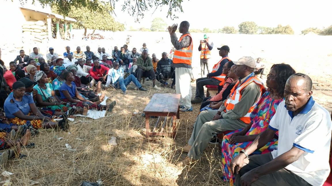 A local farmer addresses the gathering during the community dialogue.